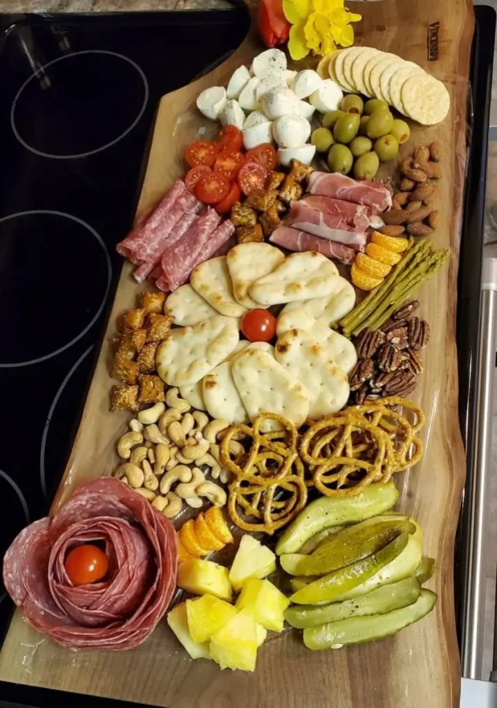 An Italian Charcuterie Board filled with meats, cheeses, nuts, olives, and pickled foods and vegetables.