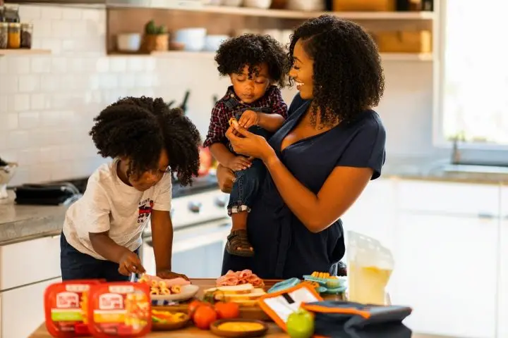 Kids helping mom in the kitchen preparing school lunch ideas