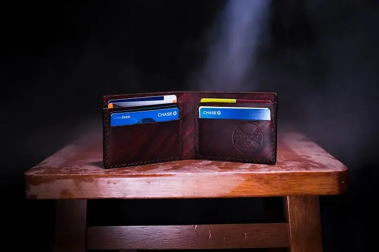 mans wallet filled with credit cards