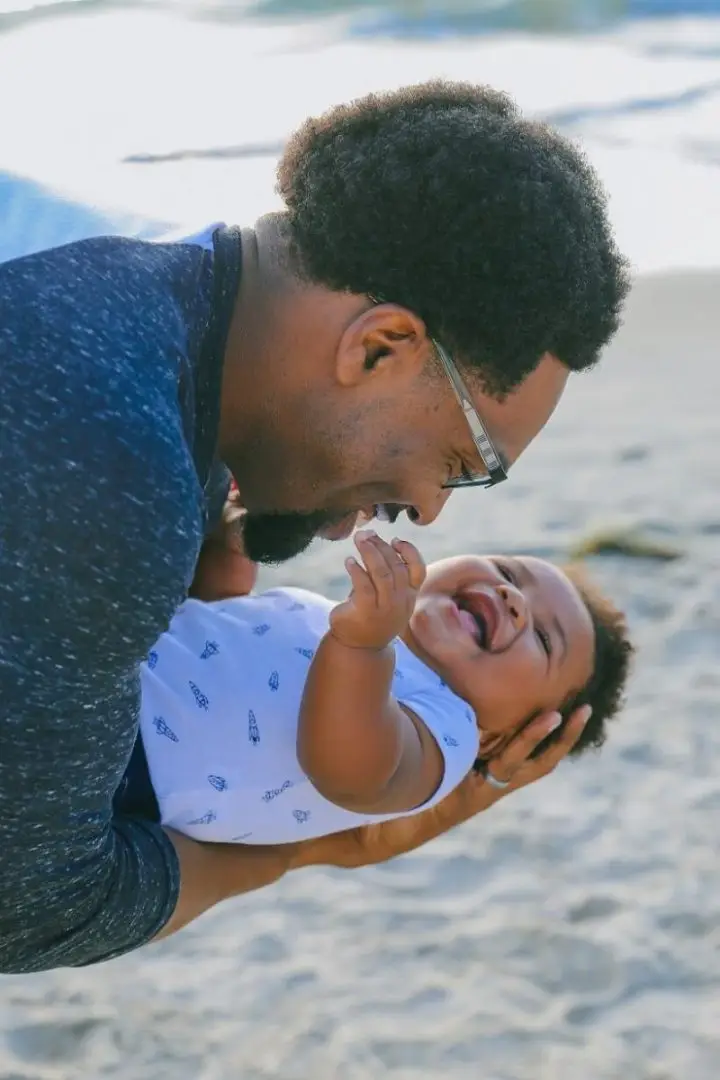 A Baby with his father at the beach. Spending time with your son or daughter for Father's Day 2021.