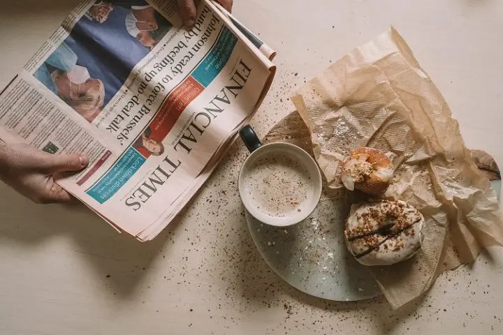Take a break to read the news and enjoy a cup of coffee and a pastry.