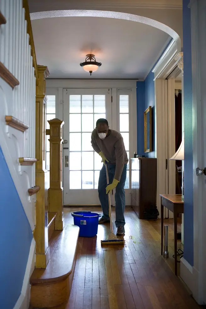 Man mopping the floor. Sharing the chores using a weekly cleaning schedule.
