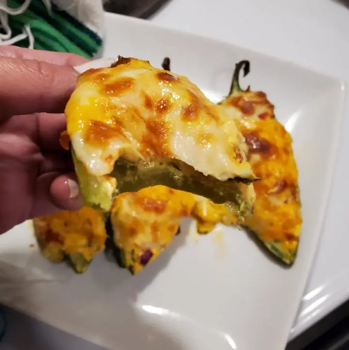 A bite of keto cheesy bacon Jalapeno poppers