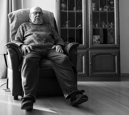 Senior sitting in a comfortable Lazy Boy recliner chair