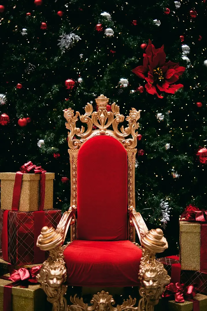 A red throne where Santa would sit but he's missing.