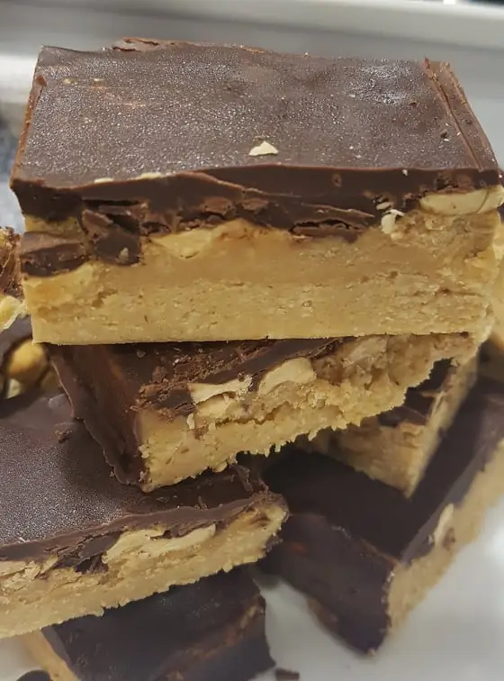 Copycat Keto Snickers Bars cut in bars on a plate for serving