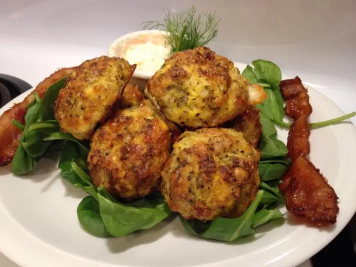 Finished Cauliflower Pizza Balls On A Plate With Two Slices Of Bacon And Ranch Dip