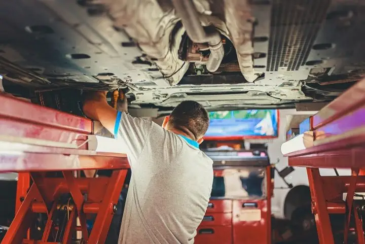 A mechanic fixing a car before the warranty runs out.