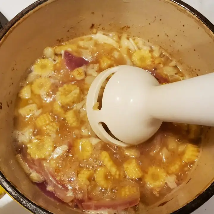 Immersion Blender to cream the mini corn cobs, onions and celery in the broth
