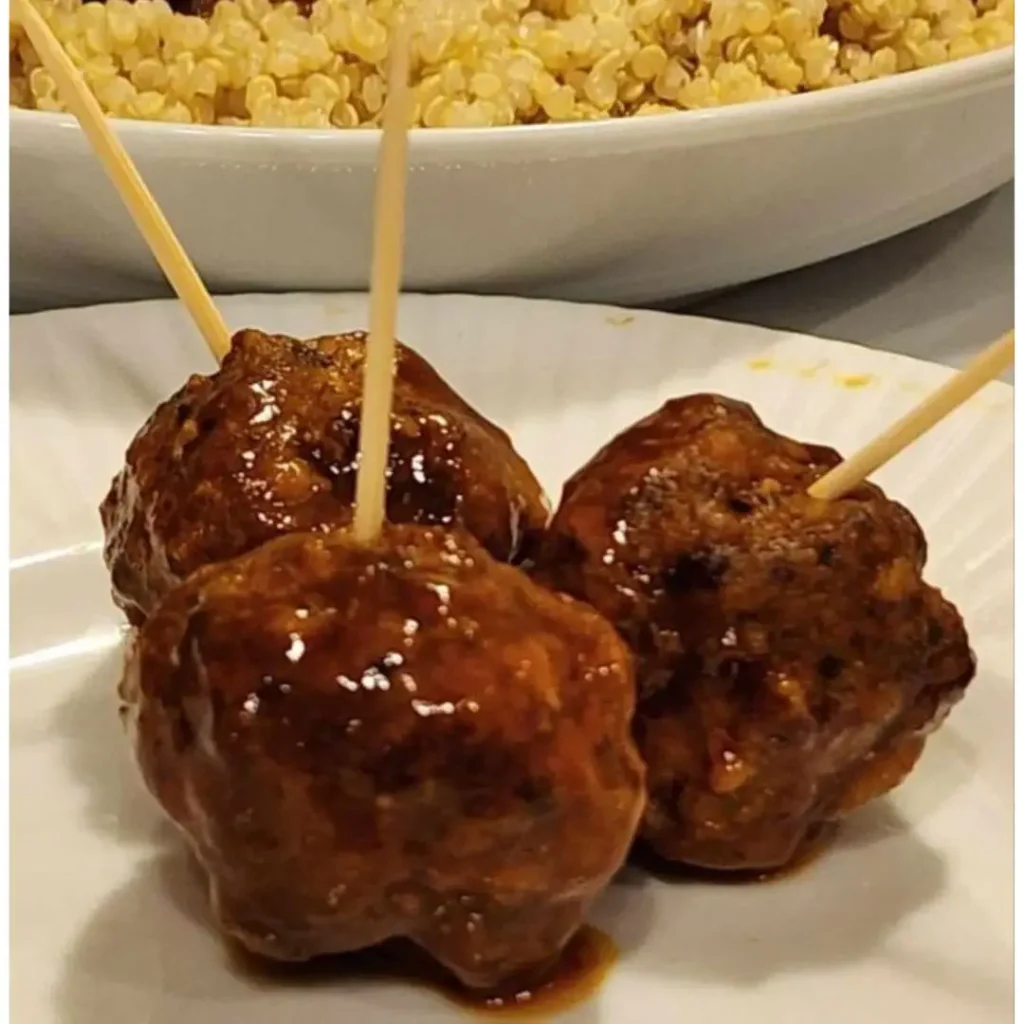 Mini Cranberry Orange Meatballs on quinoa and with party sticks for appetizers