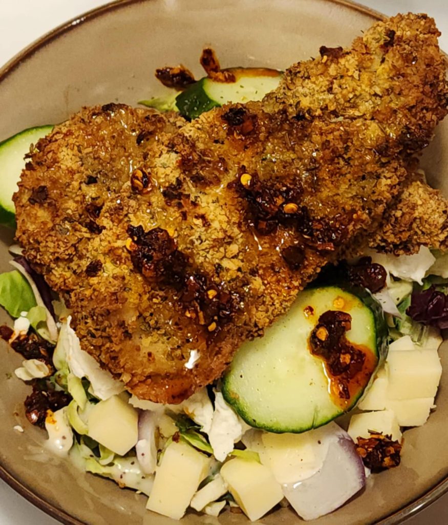 Air Fryer Chicken Breast With Chili Oil Over Top Garden Greens