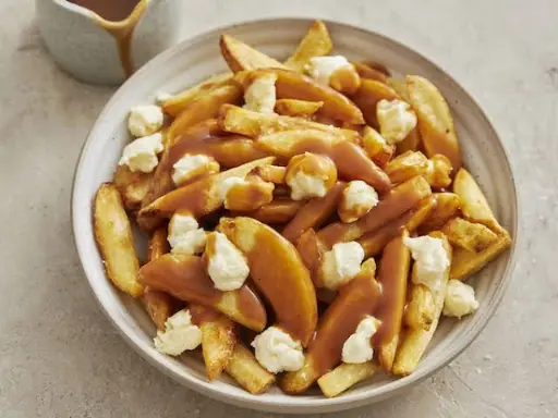 Poutine is a Canadian Dish made with fries, gravy and cheese curds.