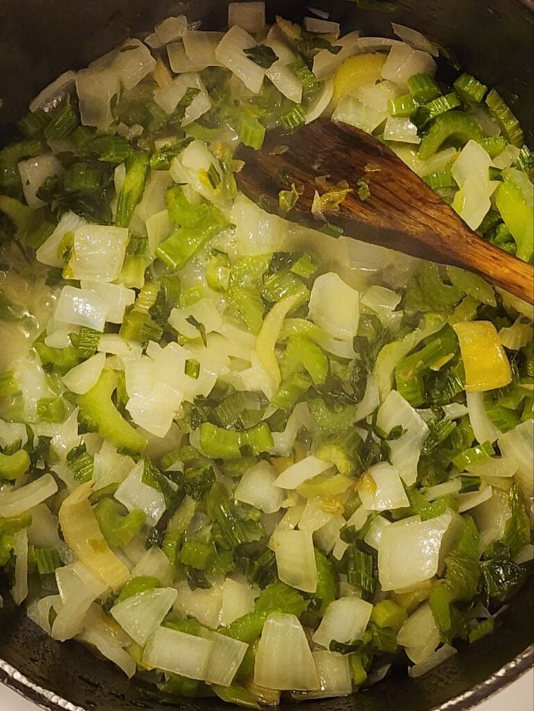Sautéed chopped celery and onions in a cooking pot for homemade Thanksgiving stuffing